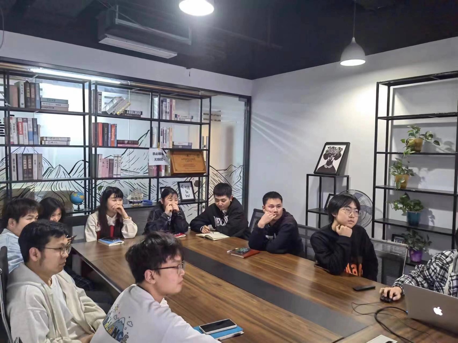 PC CARGO team members in conference room discussion with bookshelf background