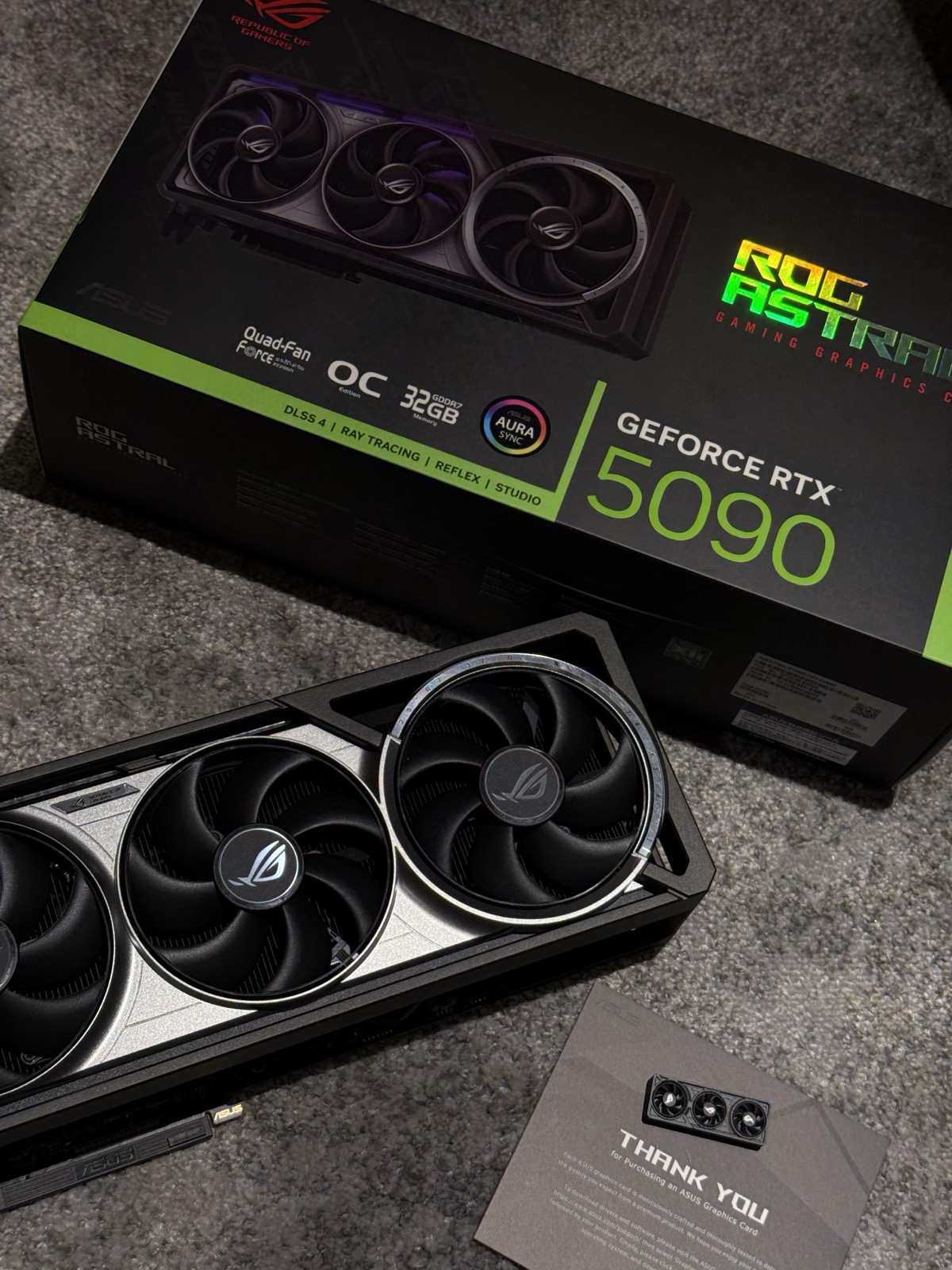 ASUS ROG Strix GeForce RTX 5090 graphics card unboxing showing retail box and actual GPU