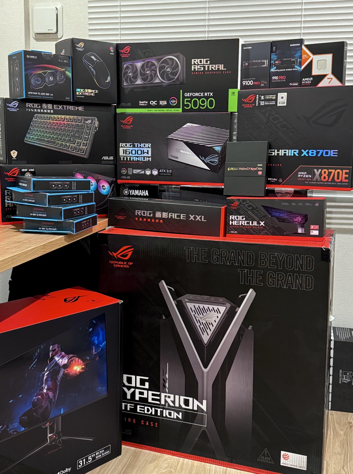 ASUS ROG RTX 5090, motherboards, keyboards, mouse, monitors and other PC components boxes stacked together in original factory packaging